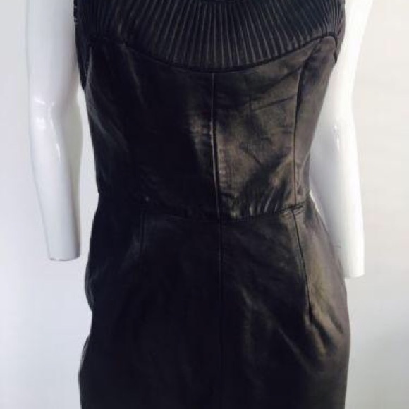 Black leather  strapless dress. 

Features a sweethart plunge cleavage. - Picture 2 of 11